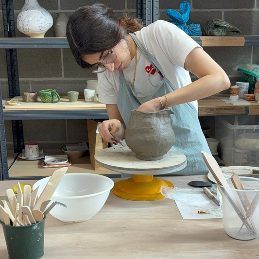 woman making a vase from clay at pottery studio ldn